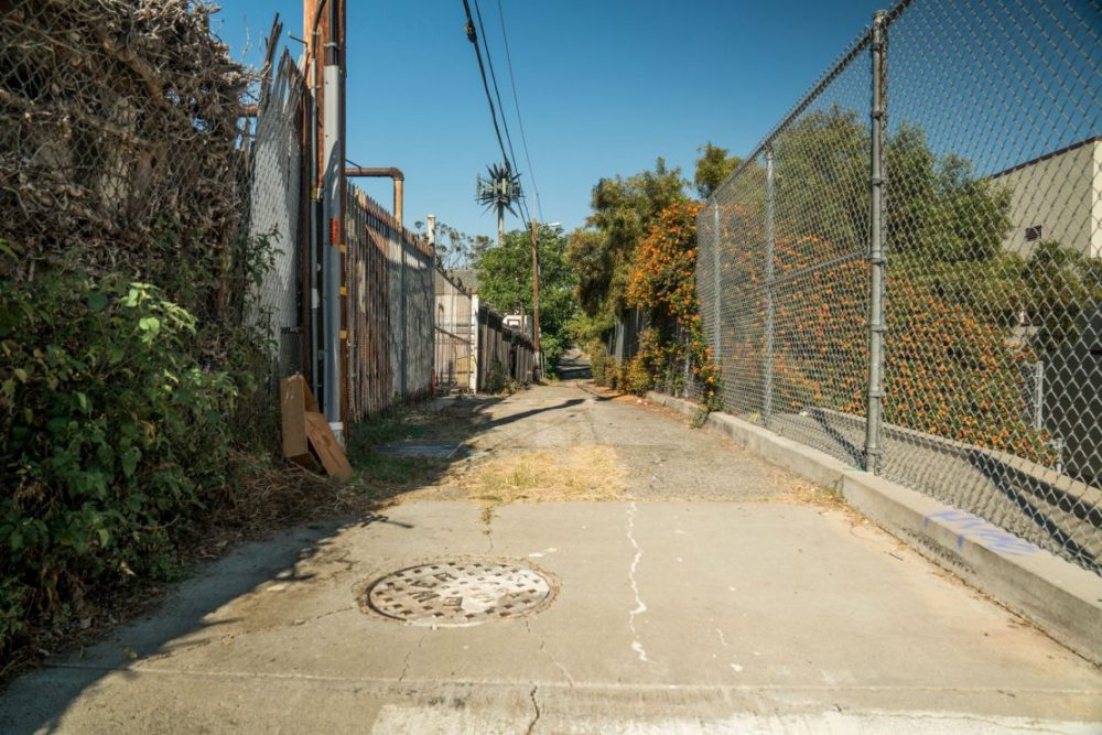 Back Alley Way w Fence & Sewer Grate Standing Set for Filming on Location Los Angeles