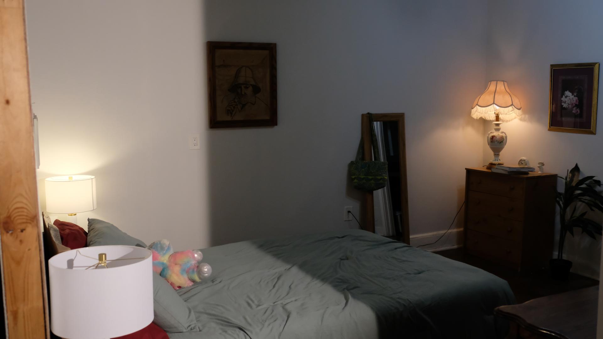 Interior bedroom film set featuring a bed, nightstands, and controlled lighting for production.