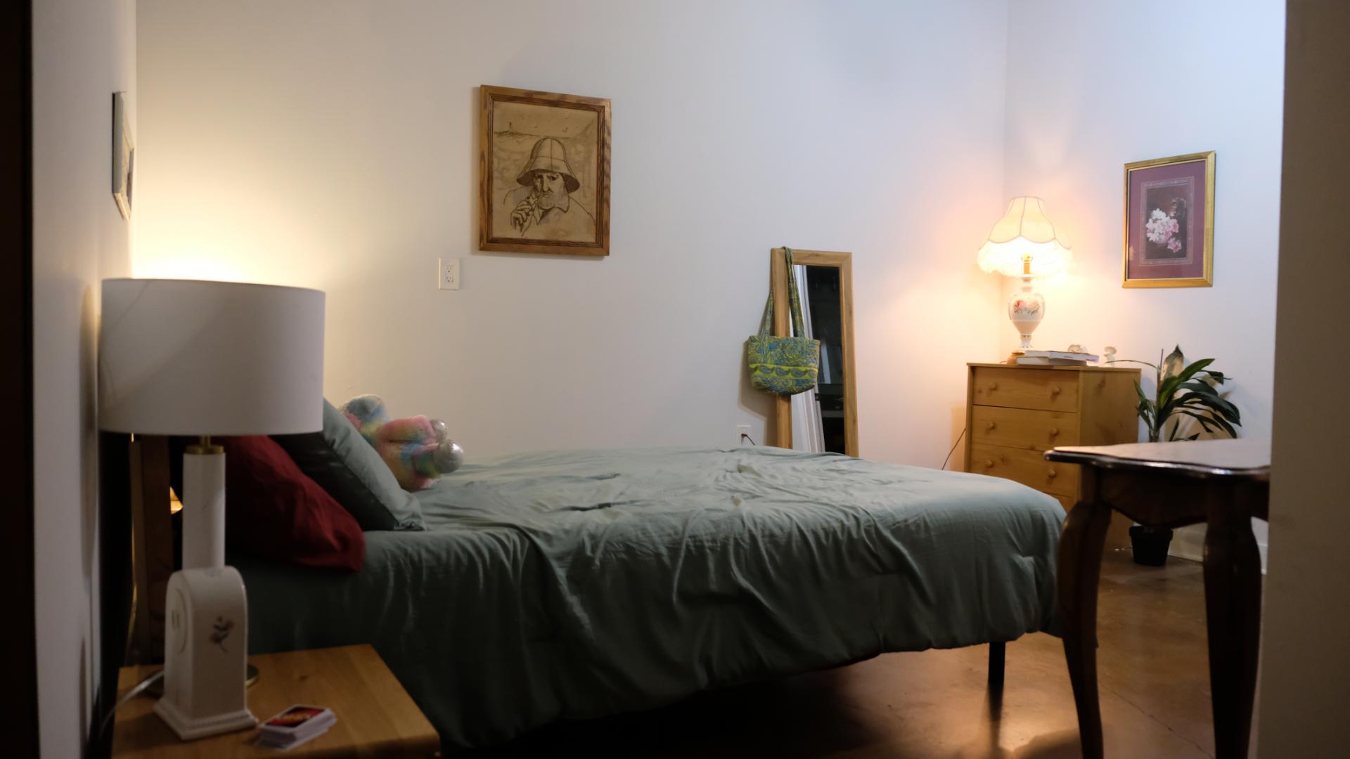 Carefully staged bedroom set designed for an emotional film scene, lit with subtle ambient light.