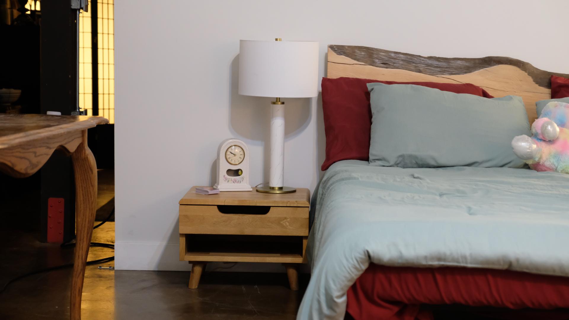 Minimalist bedroom film set creating a quiet, intimate mood for a dramatic scene.