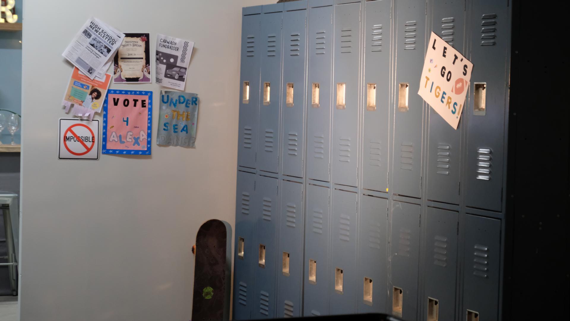 Interior school hallway lined with lockers, staged as a film set.