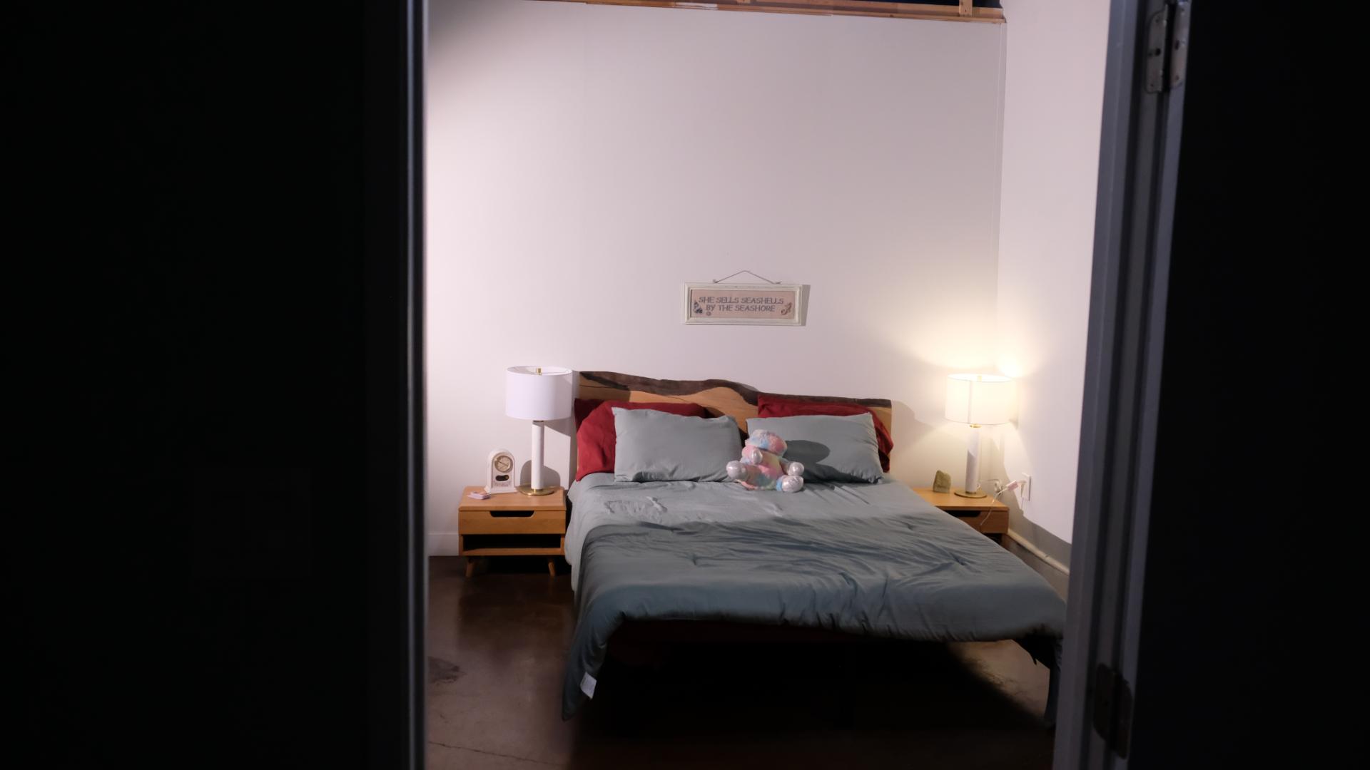 Bedroom film set staged for a narrative scene, including practical lighting and camera-ready layout.